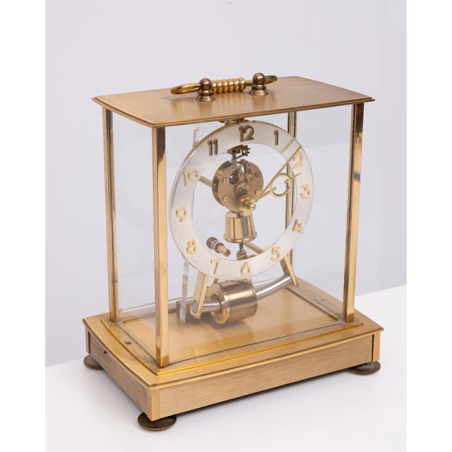 A Kundo brass electromagnetic skeleton mantel clock. The clock is a Kleninger-Obergfell electronic, electromagnetic...