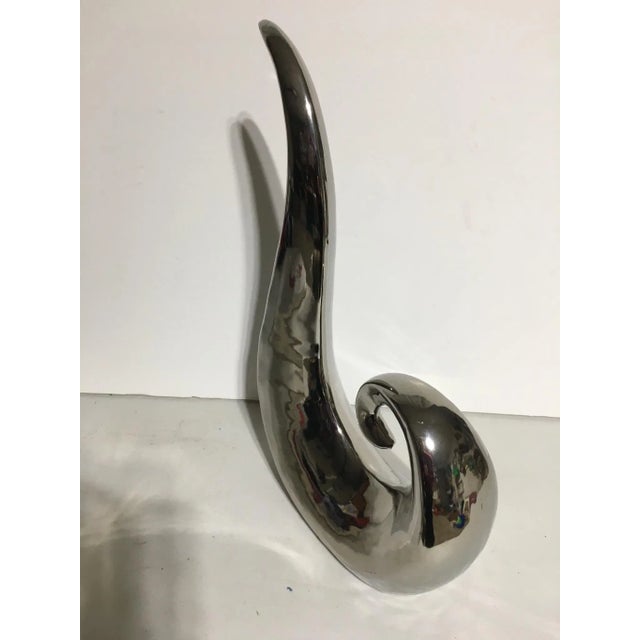 This silver glazed ceramic sculpture Was inspired by the sculpture of Brancusi The high gloss glaze has the appearance of...