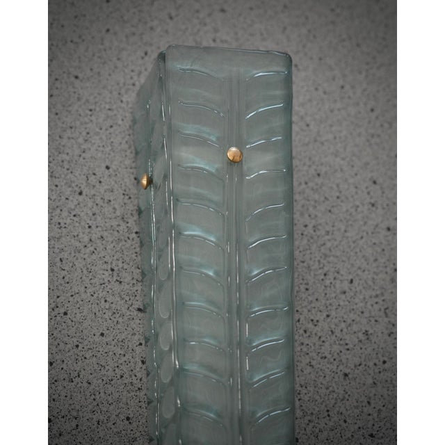 A highly original Murano glass wall light with an elongated design of glass leaves in a unique light green color. The wall...