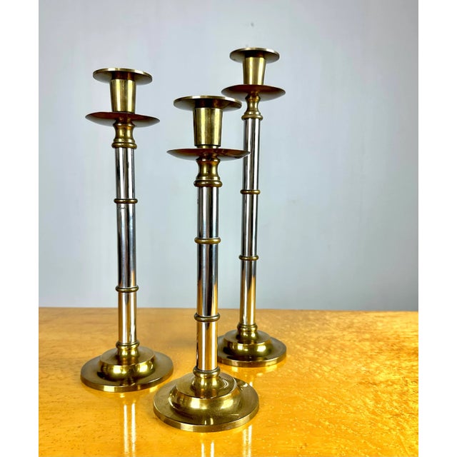A stylish set of three well-made decorative candlestick holders, likely made by Maitland Smith (unsigned). Brass with...