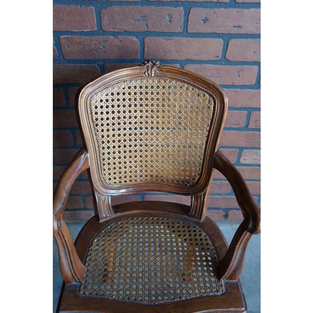 Petite and oh so sweet! This miniature French provincial cane arm chair was most likely a scaled down manufacturer sample...