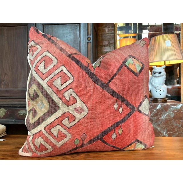 This custom pillow is made from a fragment of an antique, handwoven Kilim rug. The design features geometric and arboreal...