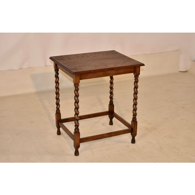 Period Edwardian oak side table from England. The top has a beveled edge and lovely graining, following down to a simple...