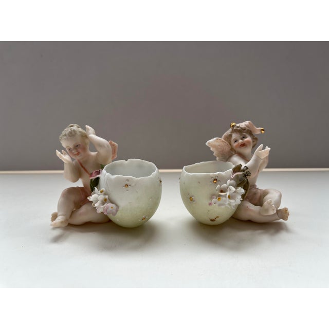 Rare Capodimonte Porcelain Pair Cherubs with Eggcups, c. 1900. Fine sculptural details and hand painting with bisque...
