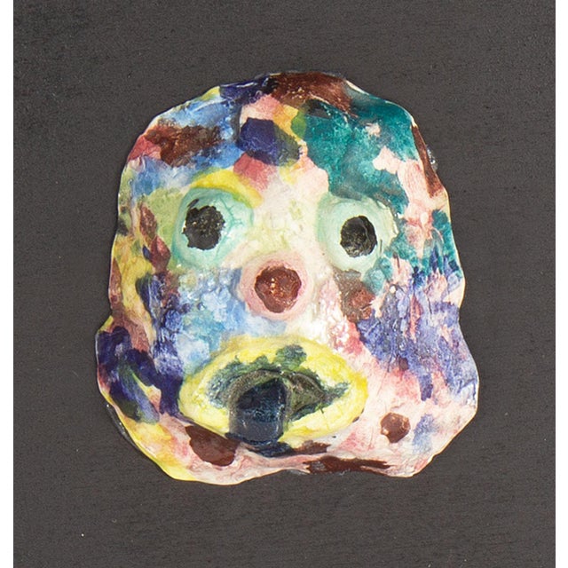 A 1970s ceramic tile by the American artist Mark Bulwinkle (born 1946). This ceramic piece depicts an abstract face...