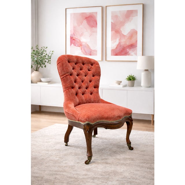 Antique Victorian tufted Mahogany French slipper chair, freshly upholstered in a rich pink velvet that adds warmth and...