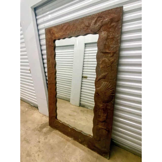 Mirror Frame Features intricate, embossed details often depicting aquatic life such as shells, fish, and seahorses...
