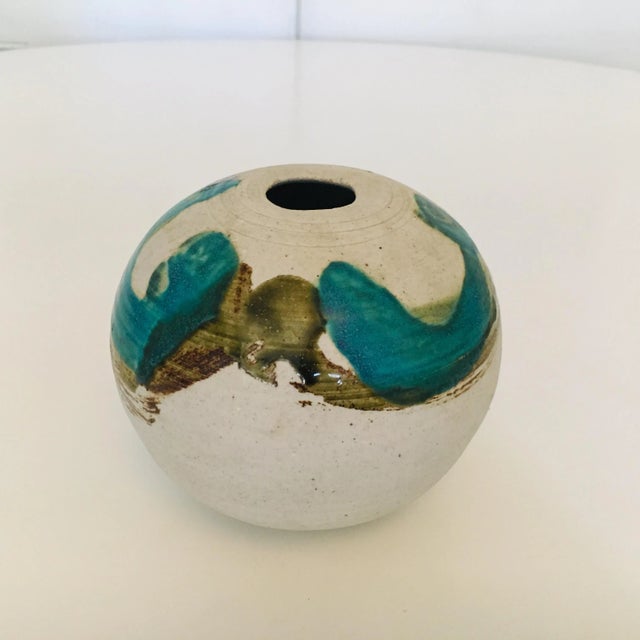 American Mid-Century Modern art pottery vase or vessel, glazed with turquoise and olive brush strokes. The piece is signed...