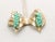 This is part of Chairish’s Costume Jewelry assortment. 1950s goldtone faux-turquoise beaded leaf clip earrings. Marked...