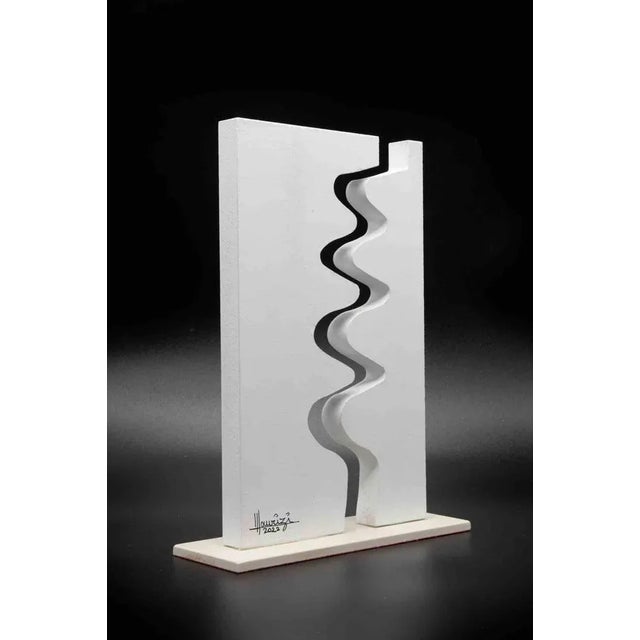 Abstract composition in white is a sculpture realized by Tonino Maurizi, in 2022. 28x16 cm. Handsigned in felt-tip pen....