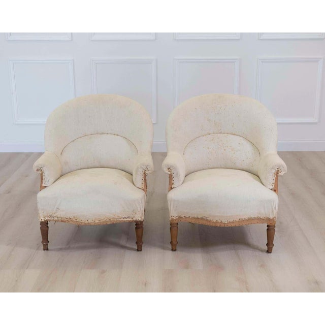 Elegant pair of French chairs from the early 20th century, displaying graceful curves and refined proportions. Carefully...