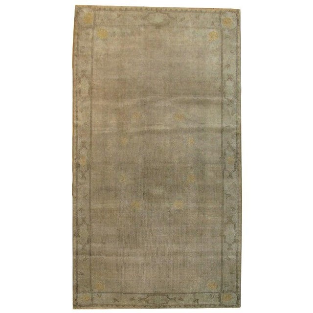 Mid-Century Turkish Oushak featuring gloomy colors and an eclectic border.