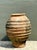 This monumental vintage terra cotta urn is a striking example of rustic Mediterranean craftsmanship, characterized by its...