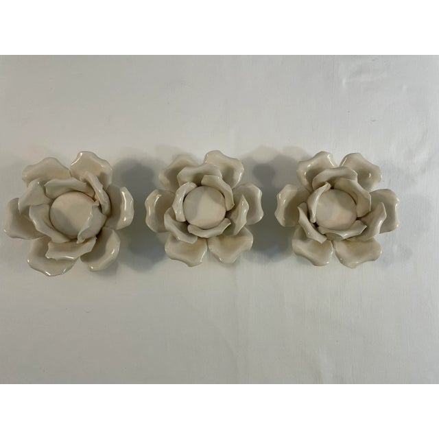 Petite Flower votive holders in cream ceramic. There are three of these darling holders. 2.5"T x 4.75"W