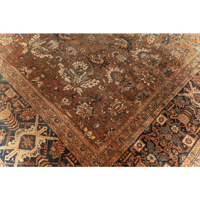 An early 20th century Persian antique Sultanabad rug, the abrashed light brown field with an allover design of stylized...