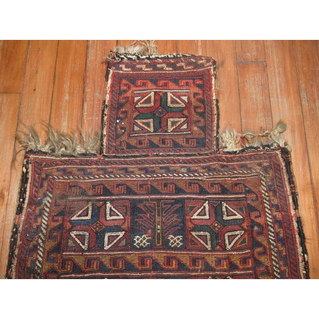A Persian flat-weave salt bag textile rug from the early 20th century with rustic tones Measures: 8' x 18'' x 22''.
