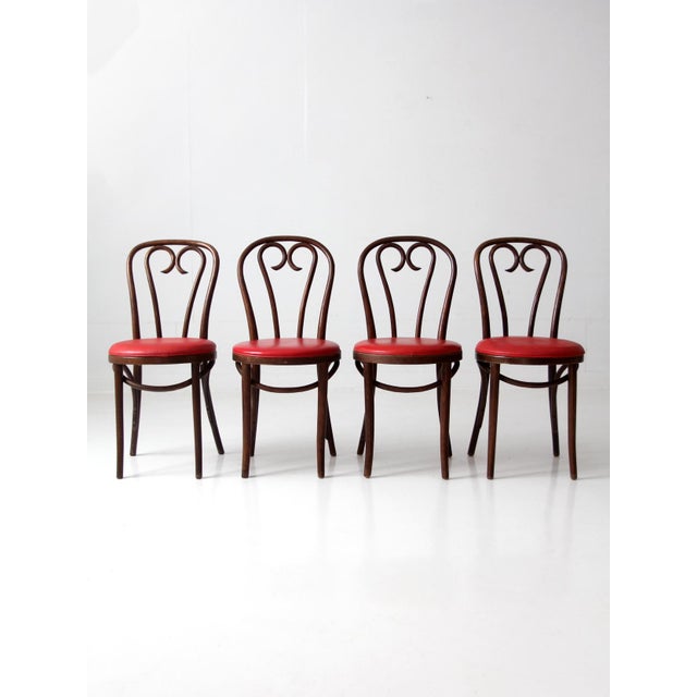 A set of four mid-century bentwood dining chairs by Polish manufacturer ZPM Radomsko, dating to the 1960s. The dark wood...