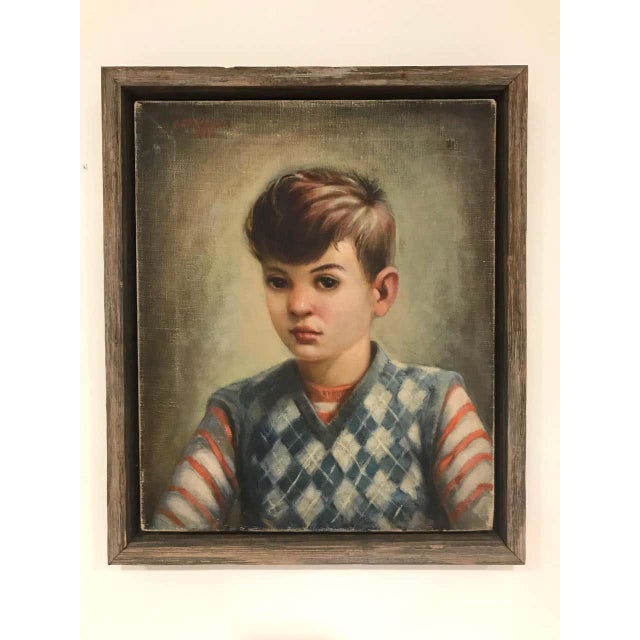 Vintage portrait of a young boy wearing a striped red shirt with blue argyle sweater. Oil on canvas painting by artist...