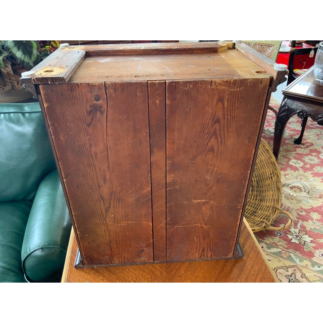 19th century mini chest with six drawers. Sloped front construction makes this a really unique item. Has had some repairs,...