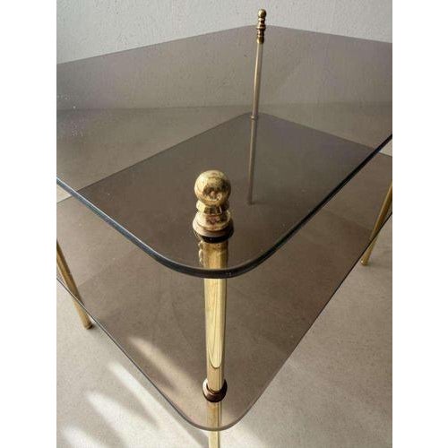 An elegant design from Germany, 1970s. Two layers of semi-transparent smoked glass rest on a slender brass frame. The...