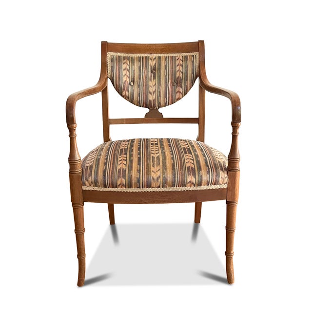 A vintage Hepplewhite armchair with a shield back, gentle curved arms and tapered legs. The shield style chair has a multi...