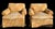 A comfortable and classically proportioned pair of English roll arm club chairs, upholstered in a warm golden ground...