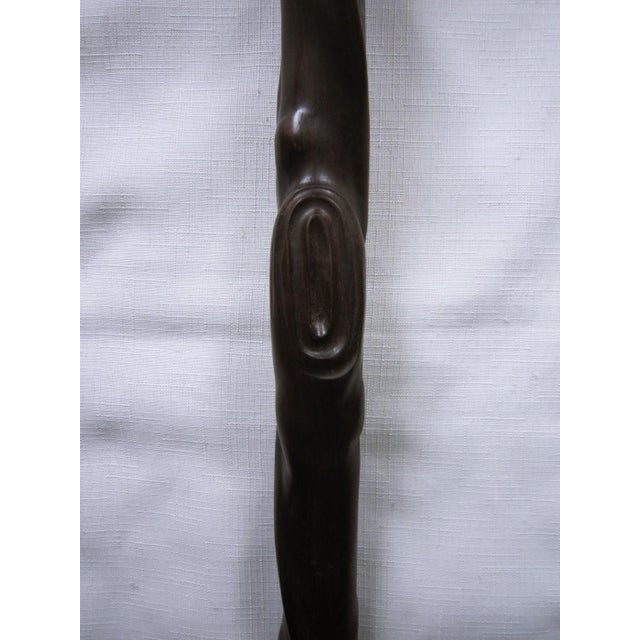 Beautiful carved wood walking cane from Africa. Purchased out of an estate, it appears to be made out of ebony because of...