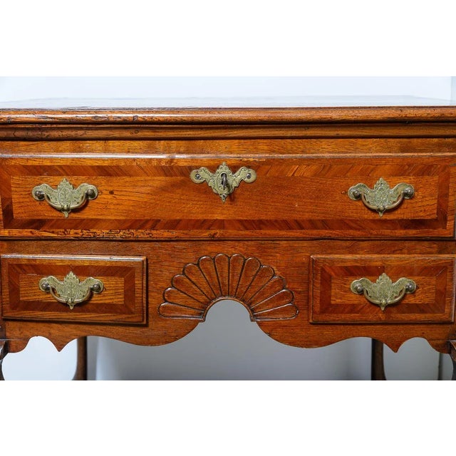 C.1800,Antique Queen Anne style elm low boy with mahogany banding, chased brass hardware on cabriole legs and a pad foot....