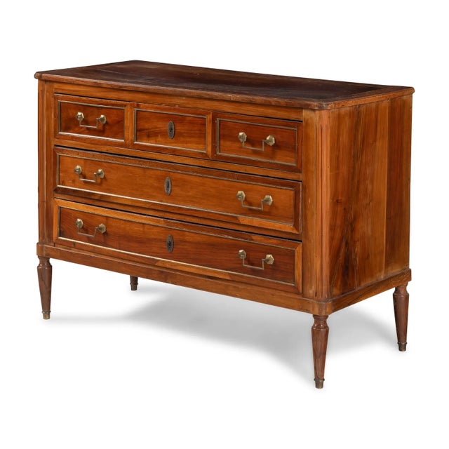A handsome French Directoire period fruitwood commode dating to the late 18th century, circa 1790–1800. The restrained...