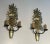 This very beautiful pair of wall sconces is composed of a decorative bronze piece representing a fruit bowl with wrought...