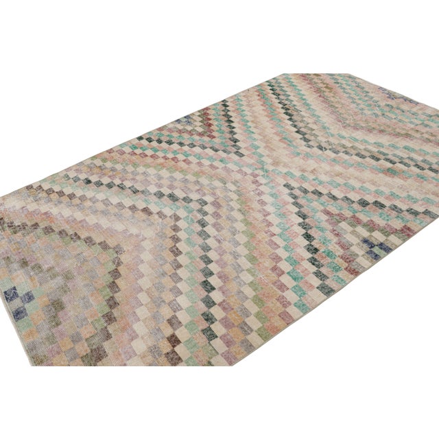 Handknotted in wool, this 5x9 vintage rug originates from Turkey, circa 1960-1970 and is believed to hail from the Turkish...