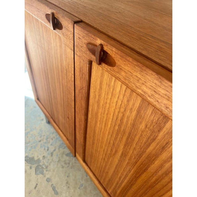 This teak chest of drawers is an absolutely exquisite design by the renowned designer H. W. Klein and a prime example of...