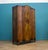 A striking 1930s Art Deco wardrobe in richly figured walnut, with a beautiful bookmatched grain creating a bold central...