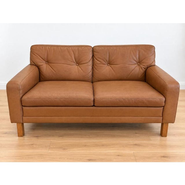Made in Denmark and designed by Peem Oy, this is a beautiful original 2 Person sofa upholstered in soft cognac leather,...