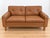 Made in Denmark and designed by Peem Oy, this is a beautiful original 2 Person sofa upholstered in soft cognac leather,...