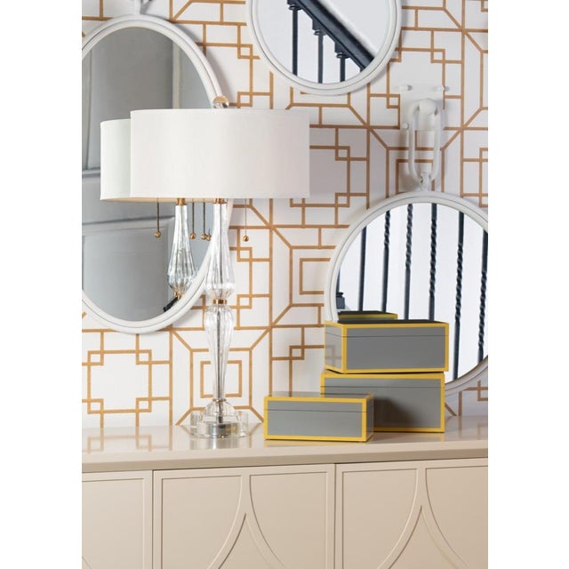 Naomi lamp is an elegant crystal and brass 32" table lamp. Its gracefully curved hourglass silhouette is topped with a...