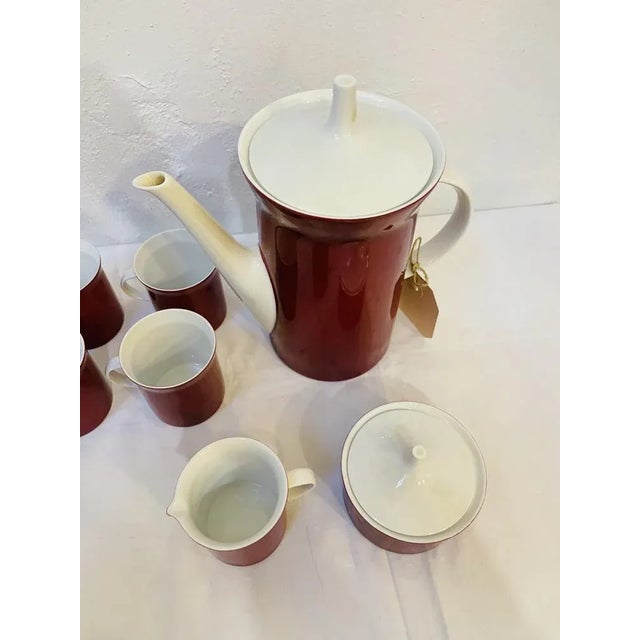 The set consists of 21 parts: A coffee pot, a milk jug, four cups, a sugar can, eight saucers, six cake plates This piece...