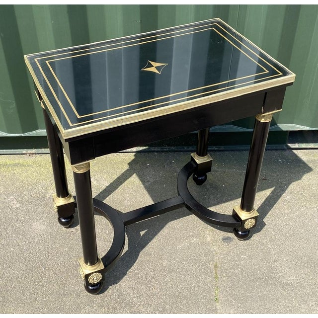 An extremely fine quality French Empire design piece of furniture. Made from Mahogany which is ebonised and having very...