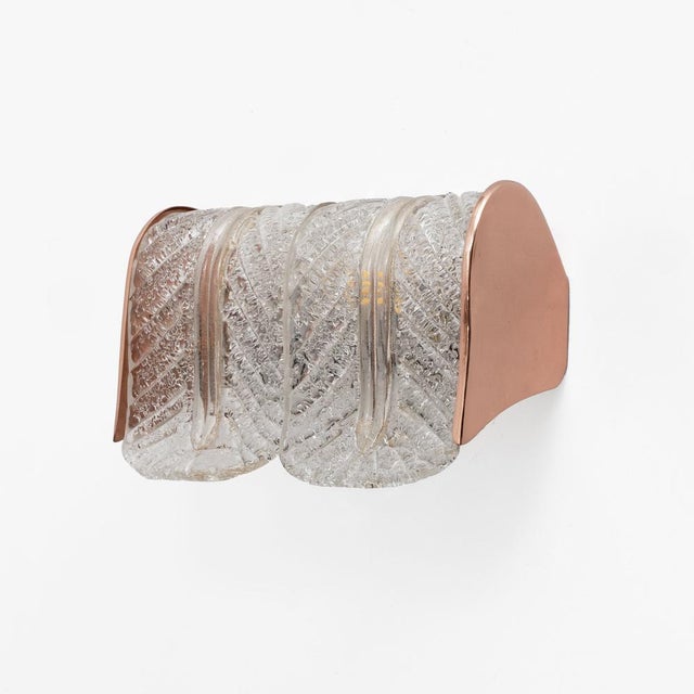 An elegant pair of wall lamps by Barovier & Toso, made in Italy around the 1970s. Each wall lamp features thick Murano...