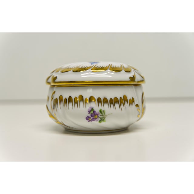 A floral hand painted small porcelain bonbonniere canister made in Hungary by Herend Porcelain Manufactory. Likely from...