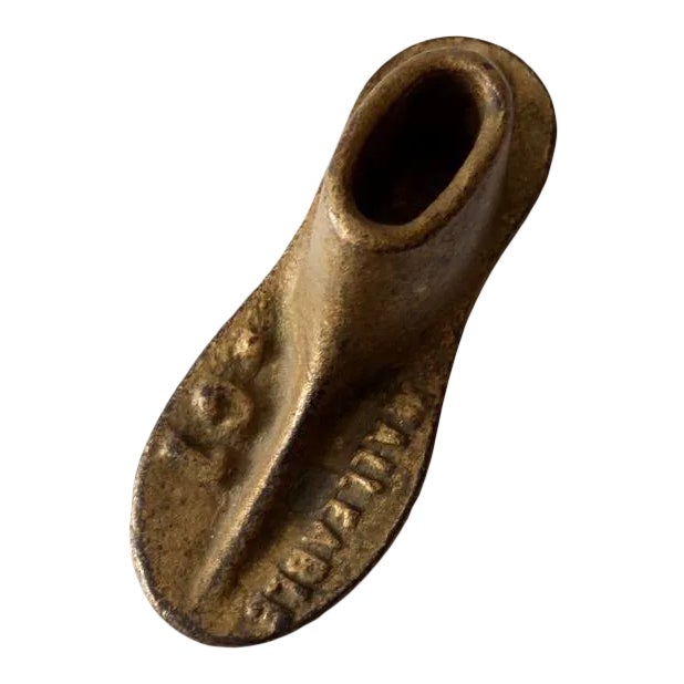 This antique cast iron child’s shoe form is marked “Malleable” and “01” on the front of the foot. Finished in a warm...