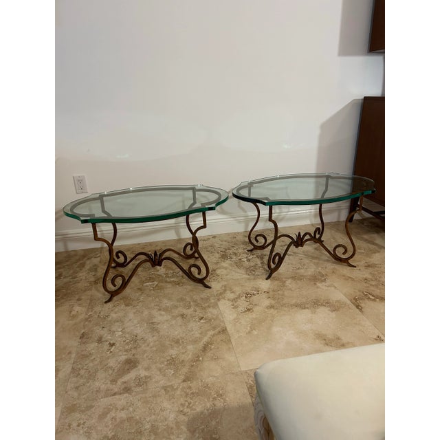 Solid heavy iron gilt metal side tables with notch-cut thick glass tops. These tables are much more than meets the eye....