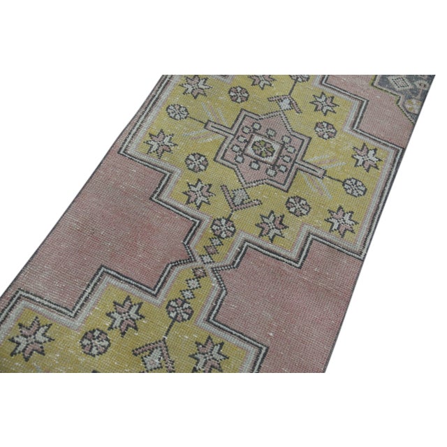 Introducing a one-of-a-kind vintage Turkish hand-knotted wool rug, carefully crafted by skilled artisans using traditional...