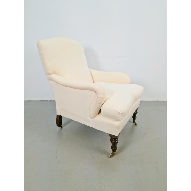 Classic English, attractive country house armchair in white fabric with wooden legs This English country house style...