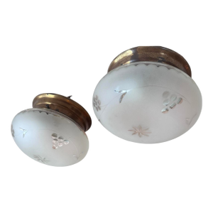 1920s American flush mounts with original old brass holders featuring leaves, berries, and star wheel-cut patterns, with frosted glass — a pair