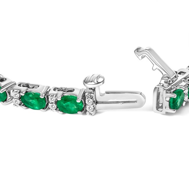 Enwrap your wrist in the opulence of the 14K White Gold Tennis Bracelet, where verdant natural oval green emeralds...