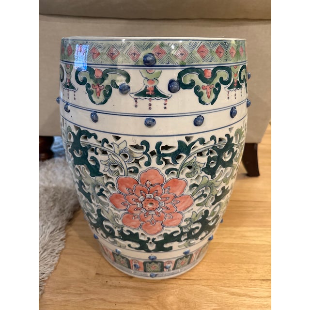 Beautiful vintage Chinese ceramic garden seat featuring an intricate openwork design with hand-painted floral and scroll...