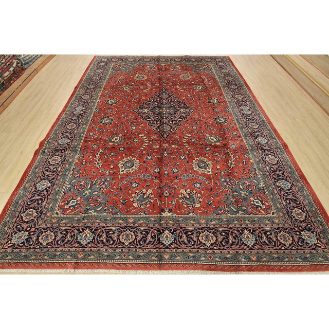 An authentic vintage traditional Sarouk rug hand-knotted with fine wool and natural dyes. This rug features a central...