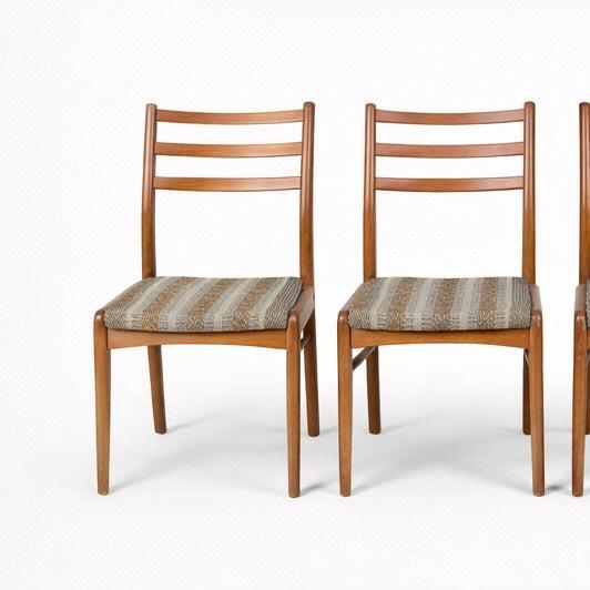 A classic set of four mid-century dining chairs by Nathan Furniture, crafted in warm teak with gently curved ladder backs...