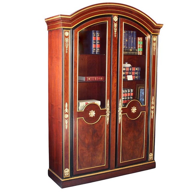 Mahogany bookcase, body decorated with gilded wood trim and gilded bronzes chiseled with Empire motifs, front with two...